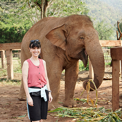 woman standing in front of an elephant